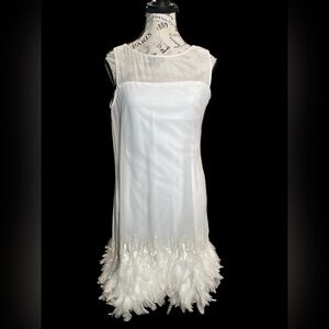 Twotwinstyle dress with a straight silhouette, and a real feather trim.